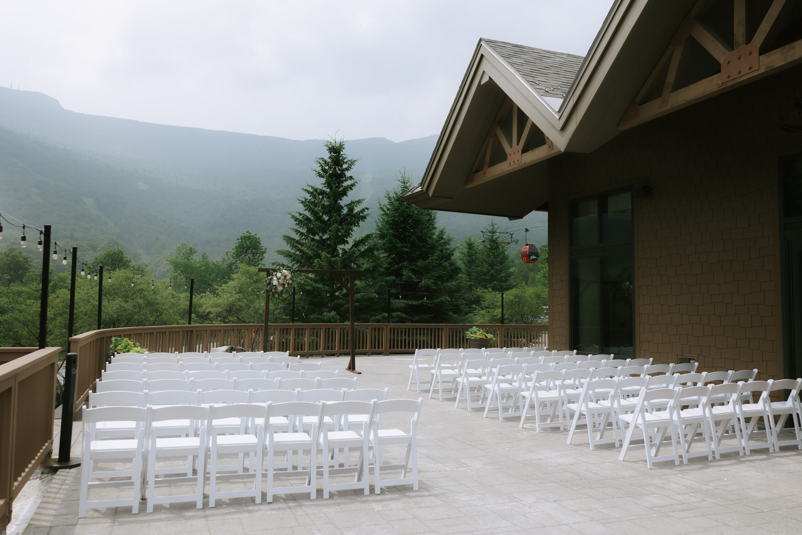 bride and groom in grassy field in Stowe, Vermont