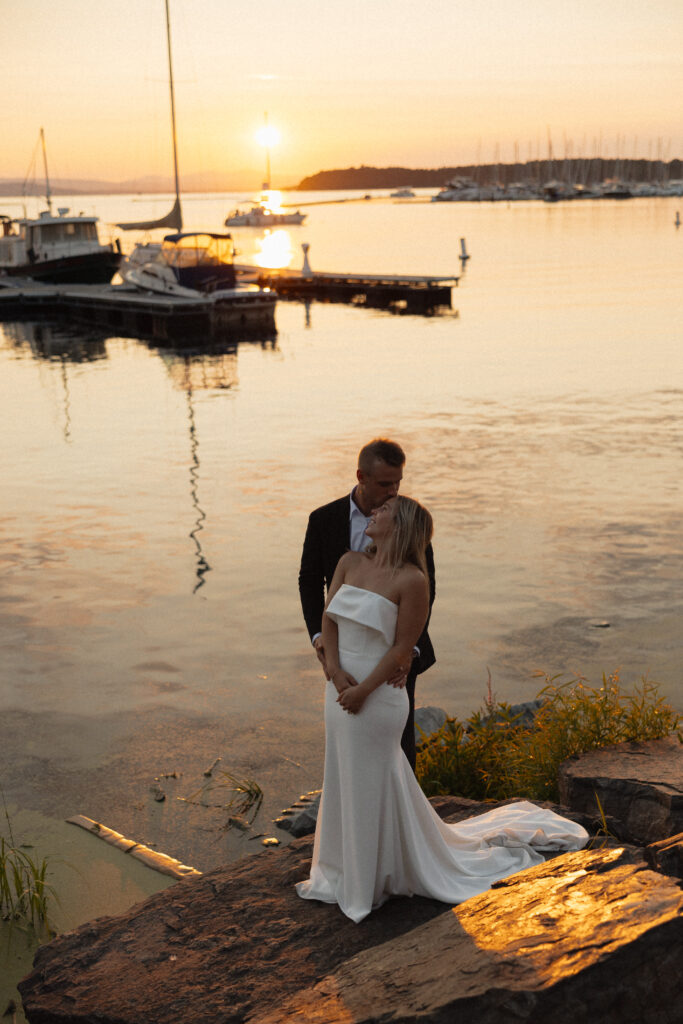 bride and groom standing together at sunset in burlington vermont