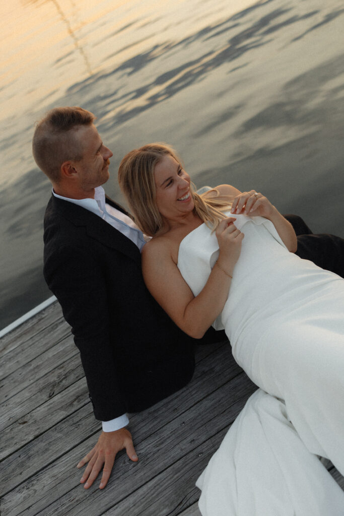 bride and groom laughing on lake champlain