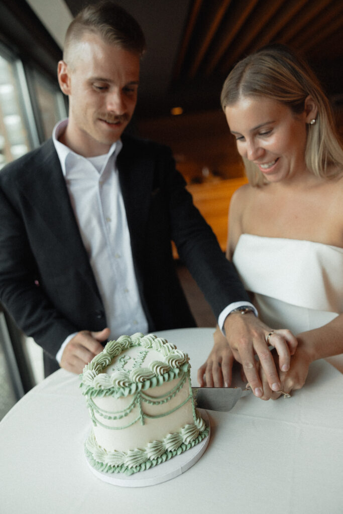 bride and groom cutting cake at their elopement in vermont