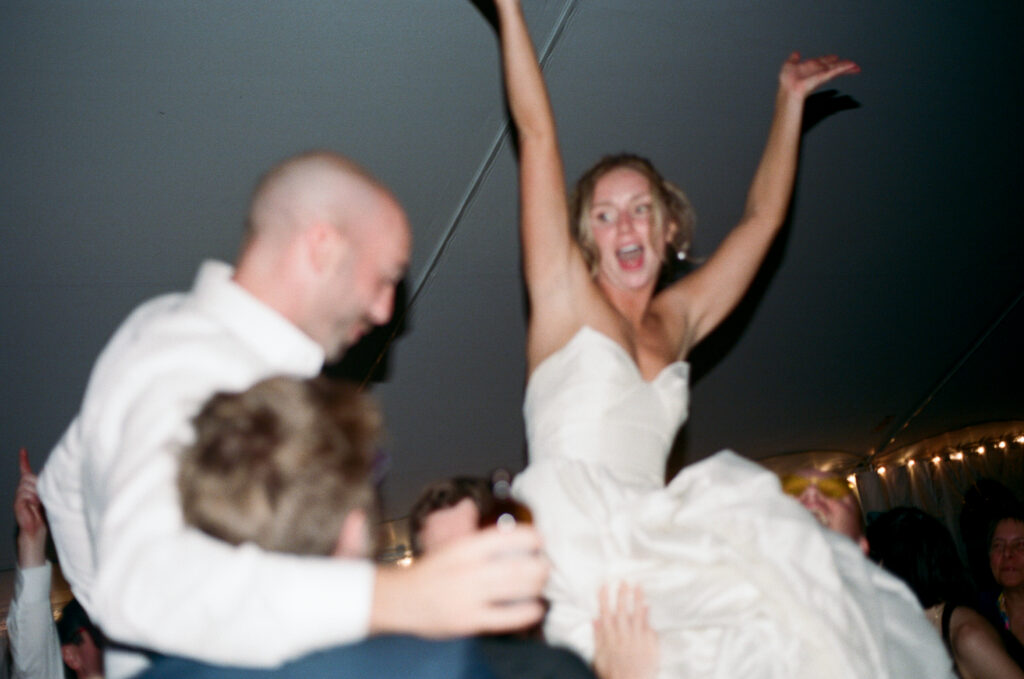 bride and groom celebrating on the dancefloor after getting married at a venue in vermont - shot on film