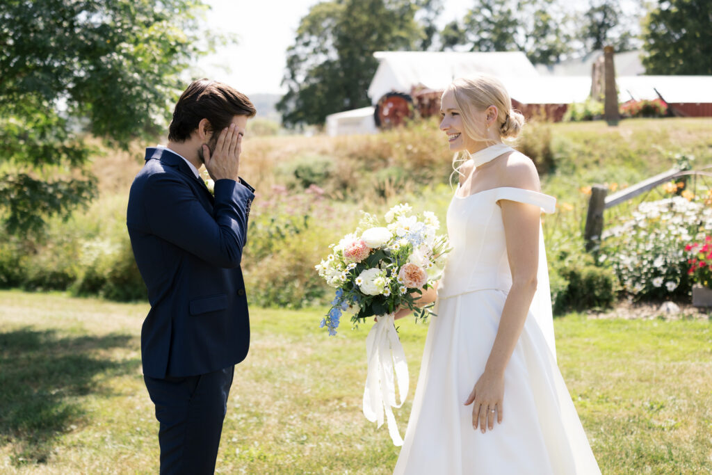 First look between bride and groom on a green summer day in New England