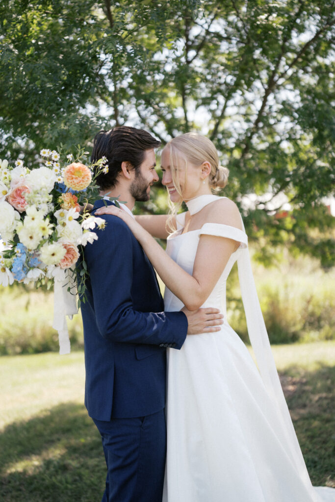Bride and groom portraits in open Vermont field with sunlit dappled trees