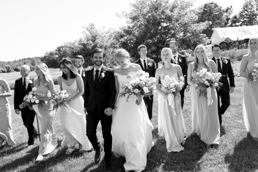 Full wedding party with bride, groom, bridesmaids, and groomsmen in Vermont outdoor setting