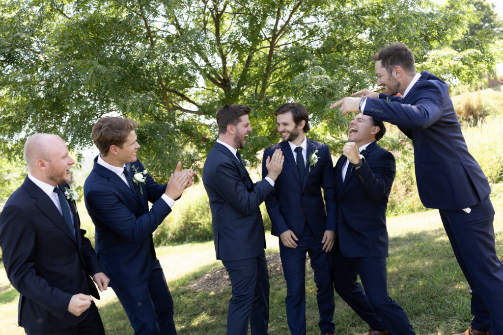 Groom with groomsmen in coordinated suits at Vermont wedding