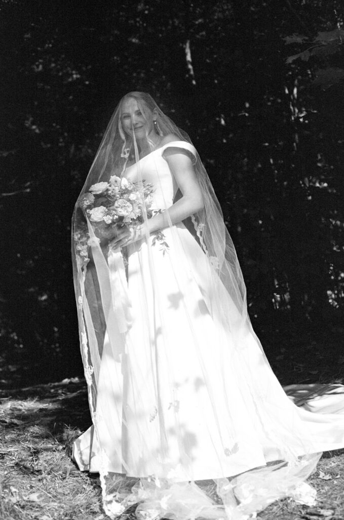 Bride portrait in sun with dark contrast behind her
