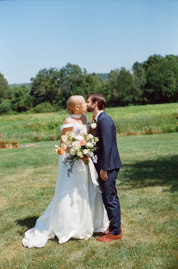 film portrait of birde and groom outside on summer day