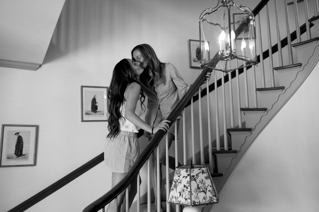 Candid photo of mother of the bride kissing the bride’s cheek before getting dressed at a Vermont wedding