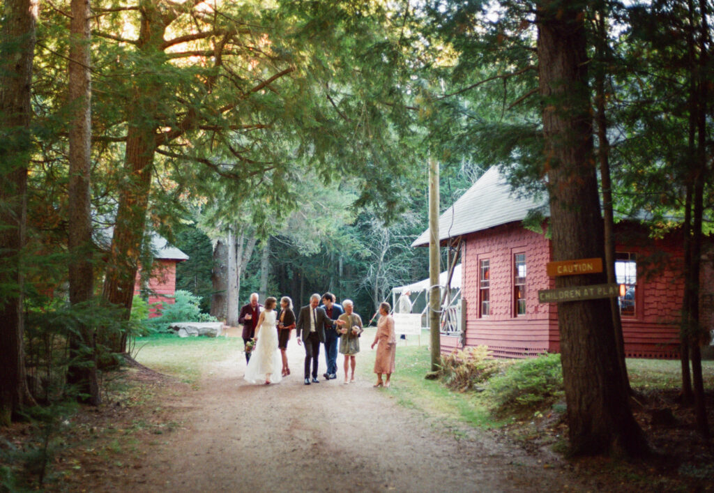 Couple walking through their reception with family members in a candid moment