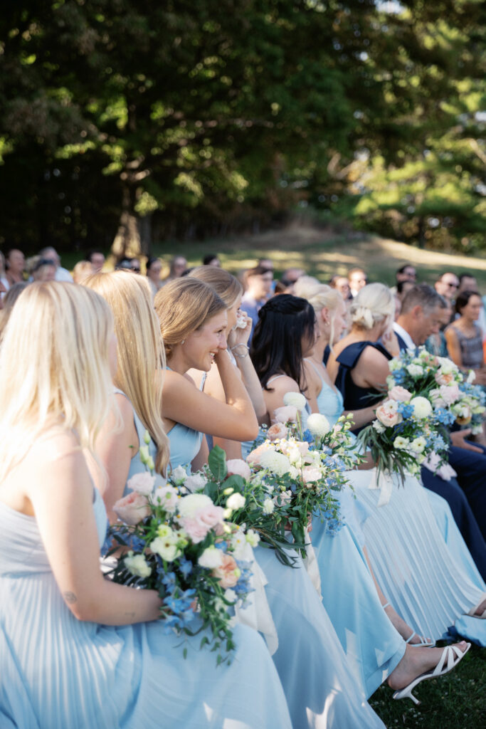 bridesmaids crying during ceremony overlooking Vermont's natural landscapes