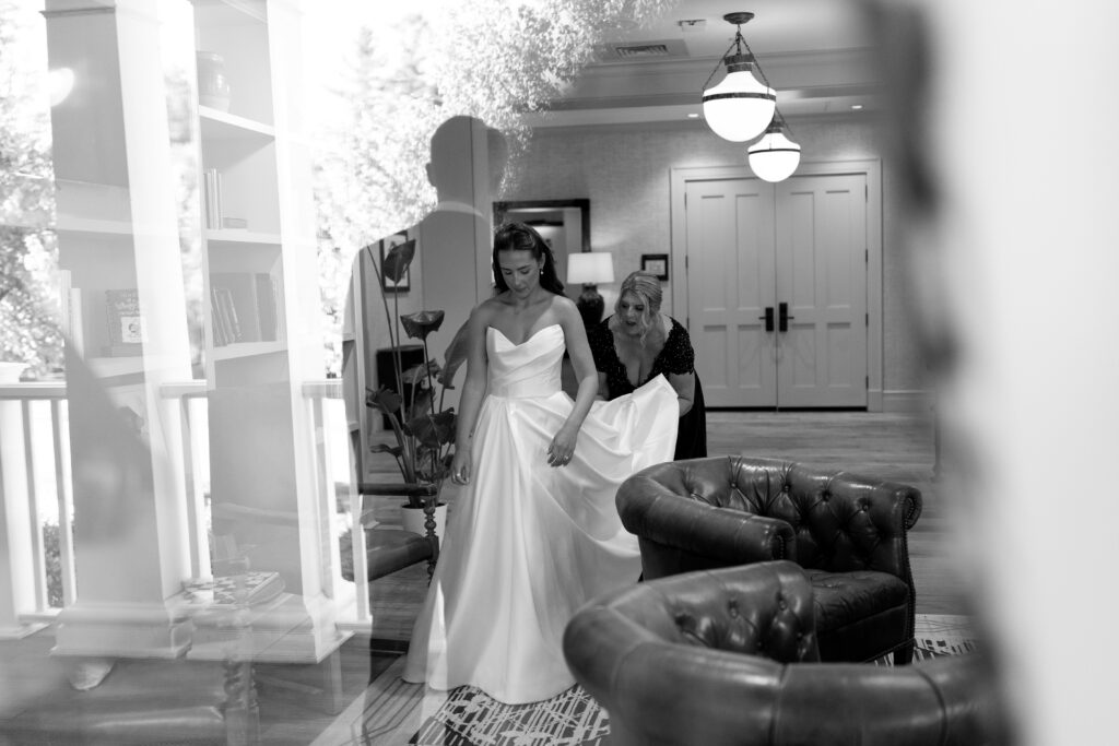 mother of bride holding dress of bride before first look