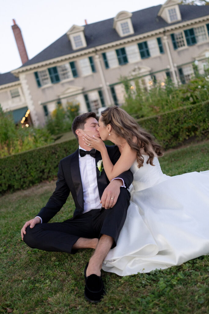 bride and groom sitting in gardens outside of Hildene Mansion