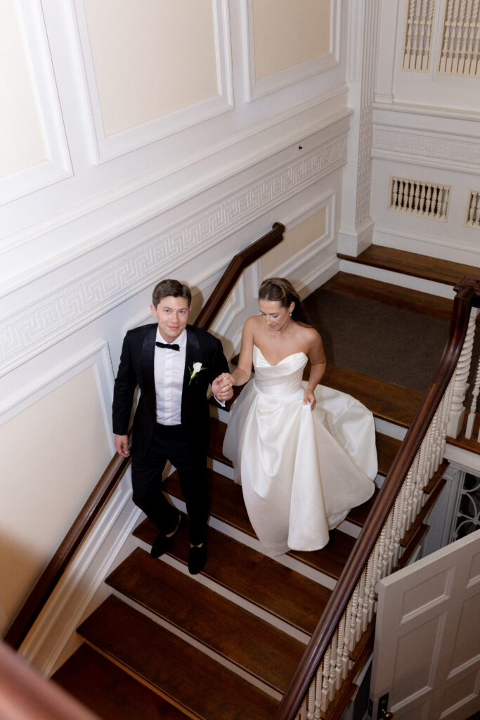 bride and groom walking downstairs together