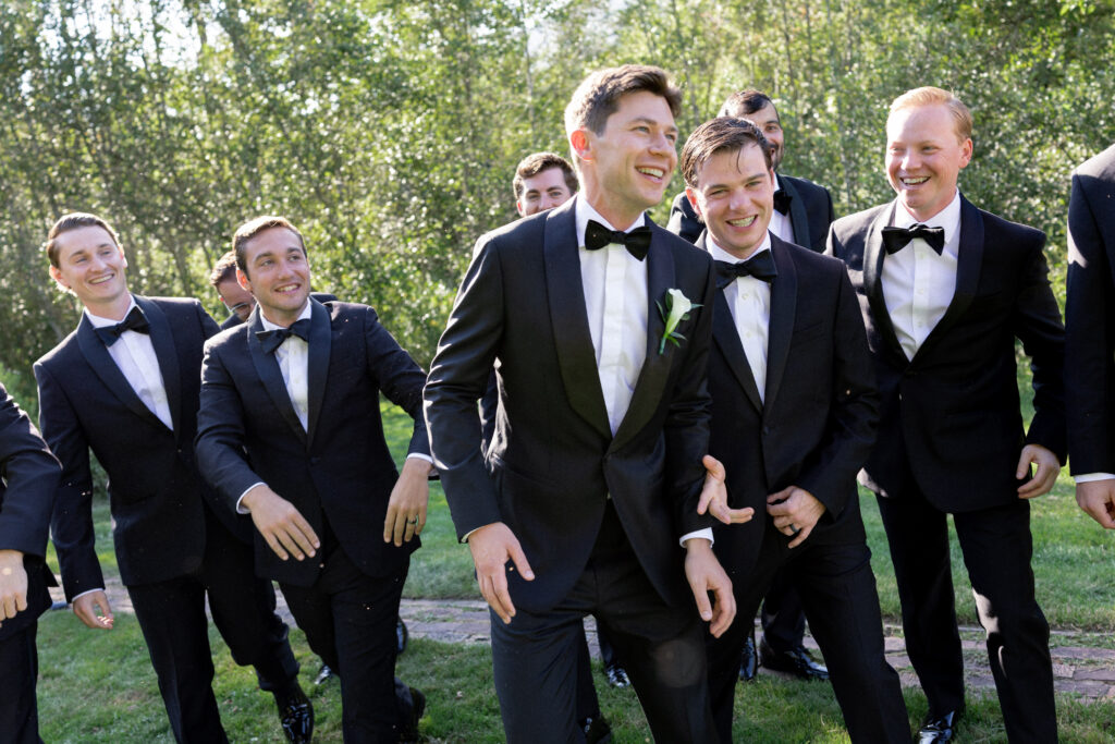 groomsmen laughing together at wedding at Hildene in Manchester VT